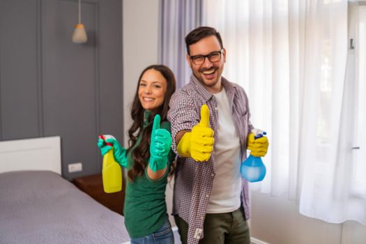 Young happy couple is ready for cleaning their apartment.