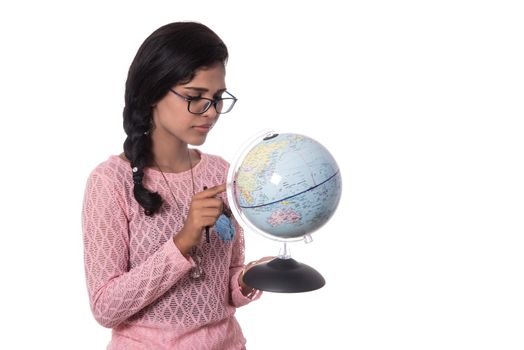 Beautiful Girl holding a world globe isolated on a white background