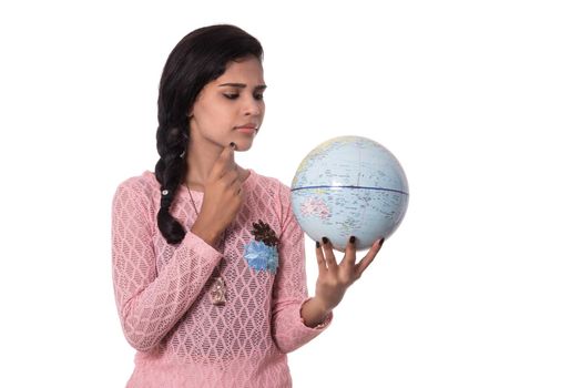 Beautiful Girl holding a world globe isolated on a white background