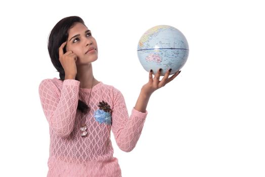 Beautiful Girl holding a world globe isolated on a white background