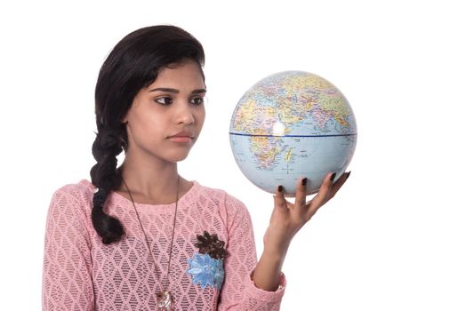 Beautiful Girl holding a world globe isolated on a white background