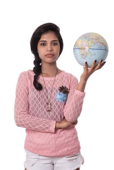 Beautiful Girl holding a world globe isolated on a white background