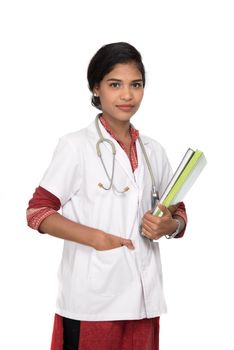 Young woman doctor holding book with stethoscope
