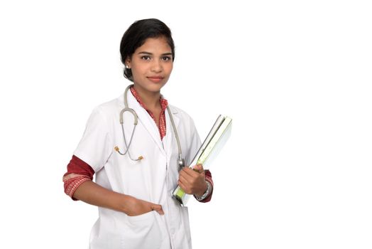 Young woman doctor holding book with stethoscope