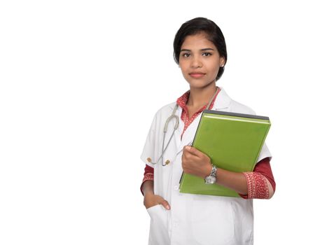 Young woman doctor holding book with stethoscope