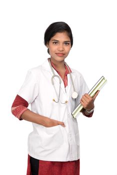 Young woman doctor holding book with stethoscope