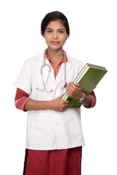 Young woman doctor holding book with stethoscope