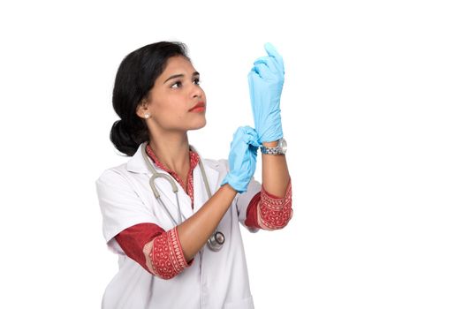 Woman doctor wears medical gloves.