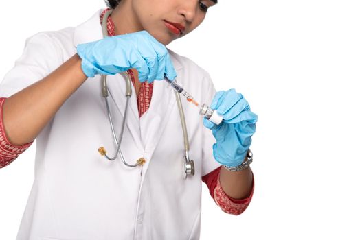 A female doctor with a stethoscope is holding an Injection or Syringe.