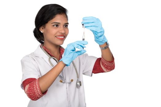 A female doctor with a stethoscope is holding an Injection or Syringe.