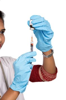 A female doctor with a stethoscope is holding an Injection or Syringe.