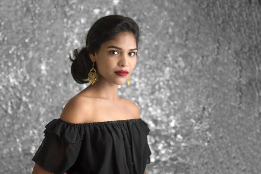 Portrait of beautiful young Girl. Closeup face of a pretty Indian model on texture background