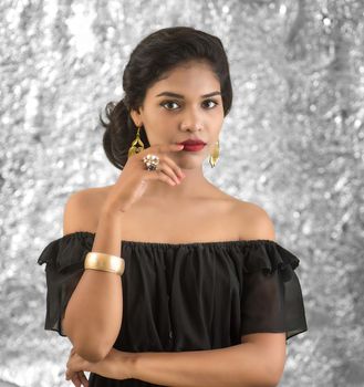 Portrait of beautiful young Girl. Closeup face of a pretty Indian model on texture background