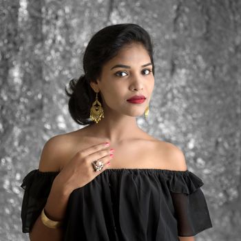 Portrait of beautiful young Girl. Closeup face of a pretty Indian model on texture background