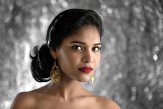 Portrait of beautiful young Girl. Closeup face of a pretty Indian model on texture background