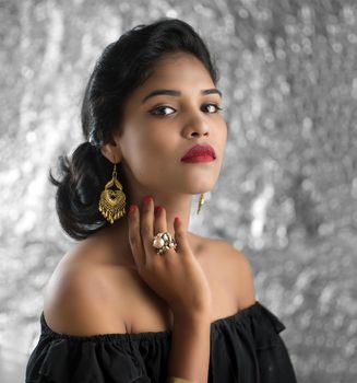 Portrait of beautiful young Girl. Closeup face of a pretty Indian model on texture background