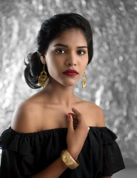 Portrait of beautiful young Girl. Closeup face of a pretty Indian model on texture background