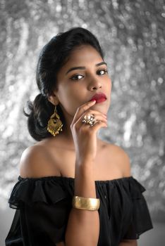 Portrait of beautiful young Girl. Closeup face of a pretty Indian model on texture background