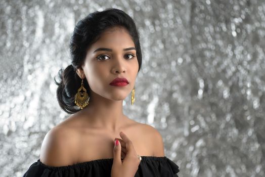 Portrait of beautiful young Girl. Closeup face of a pretty Indian model on texture background