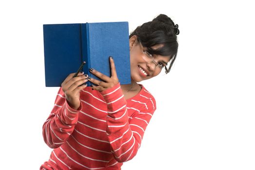 Pretty young girl holding book and posing on white background