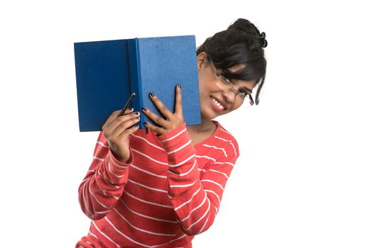 Pretty young girl holding book and posing on white background