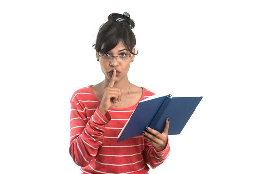 Pretty young girl holding book and posing on white background