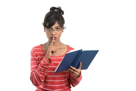 Pretty young girl holding book and posing on white background