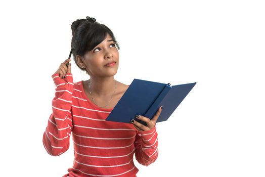 Pretty young girl holding book and posing on white background