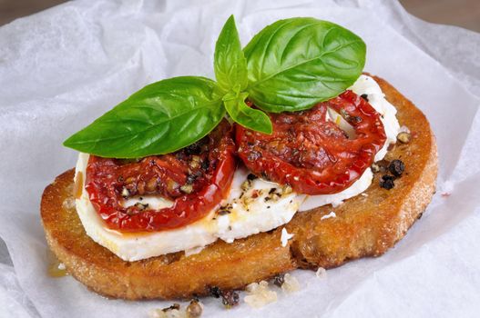 Bruschetta with feta and sun-dried tomatoes slices spiced