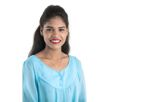 Portrait of beautiful young smiling girl posing on white background