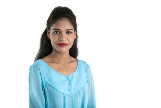 Portrait of beautiful young smiling girl posing on white background