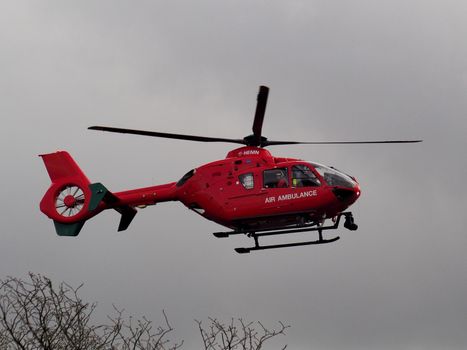 Aldermaston Wharf, Berkshire, UK, April 3 2018: Air Ambulance G-HEMN landing to attend to an emergency