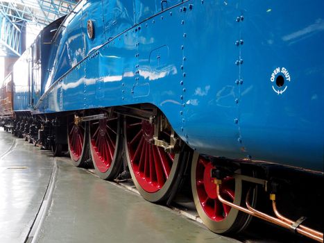 National Railway Museum, York, UK, August 19 2018: Driving wheels and coupling side rods of the London and North Eastern Railway record breaking steam locomotive Mallard A4 Pacific class 4468