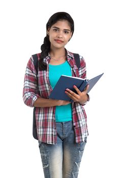 young Indian woman with backpack standing and holding notebooks, posing on a white background.