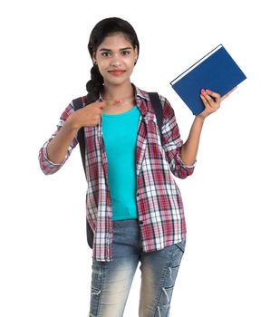 young Indian woman with backpack standing and holding notebooks, posing on a white background.