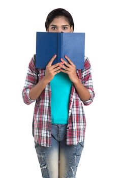 young Indian woman with backpack standing and holding notebooks, posing on a white background.