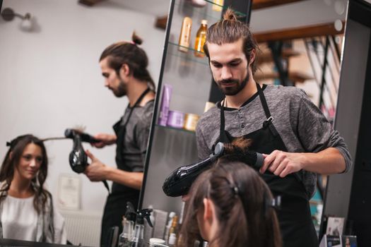 Young woman getting new hairstyle at professional hair styling saloon.