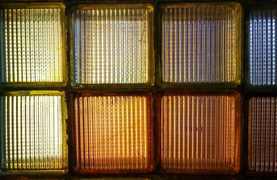 Old colored glass blocks with penetrating light, instead of a window.