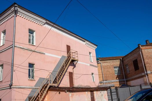 External staircase on the facade of the building. Fire escape in the open air. Emergency ladder.