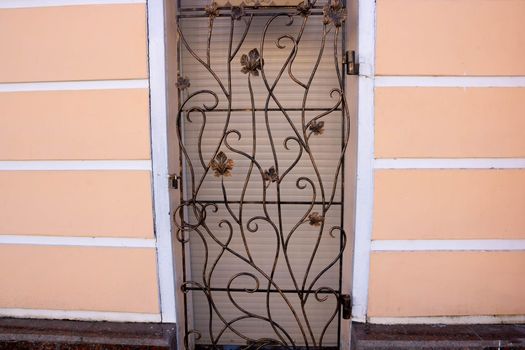 Decorative elements of buildings, old cast-iron wrought-iron grilles on doors and gates.