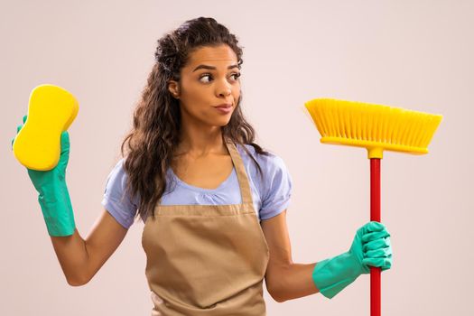 Portrait of african-american housewife who doesn't like cleaning.