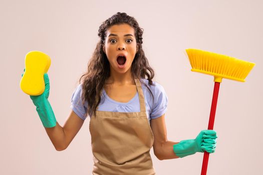 Portrait of african-american housewife who doesn't like cleaning.