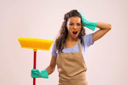 Portrait of african-american housewife who doesn't like cleaning.