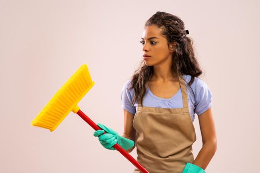 Portrait of african-american housewife who doesn't like cleaning.