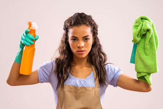 Portrait of african-american professional maid who is tired of cleaning.