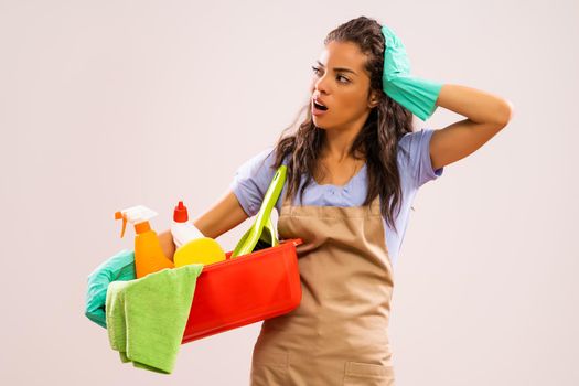 Portrait of african-american professional maid who is tired of cleaning.