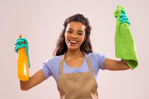 Portrait of happy and successful african-american housewife who is ready for housework.