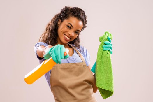 Portrait of happy and successful african-american housewife who is ready for housework.