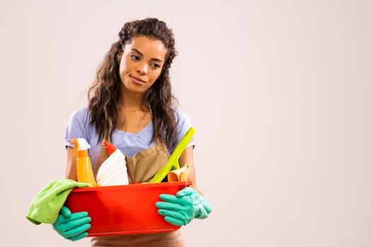 Portrait of african-american professional maid who is tired of cleaning.