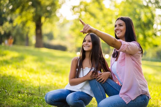 Happy family having nice time in park together. They are taking selfie.